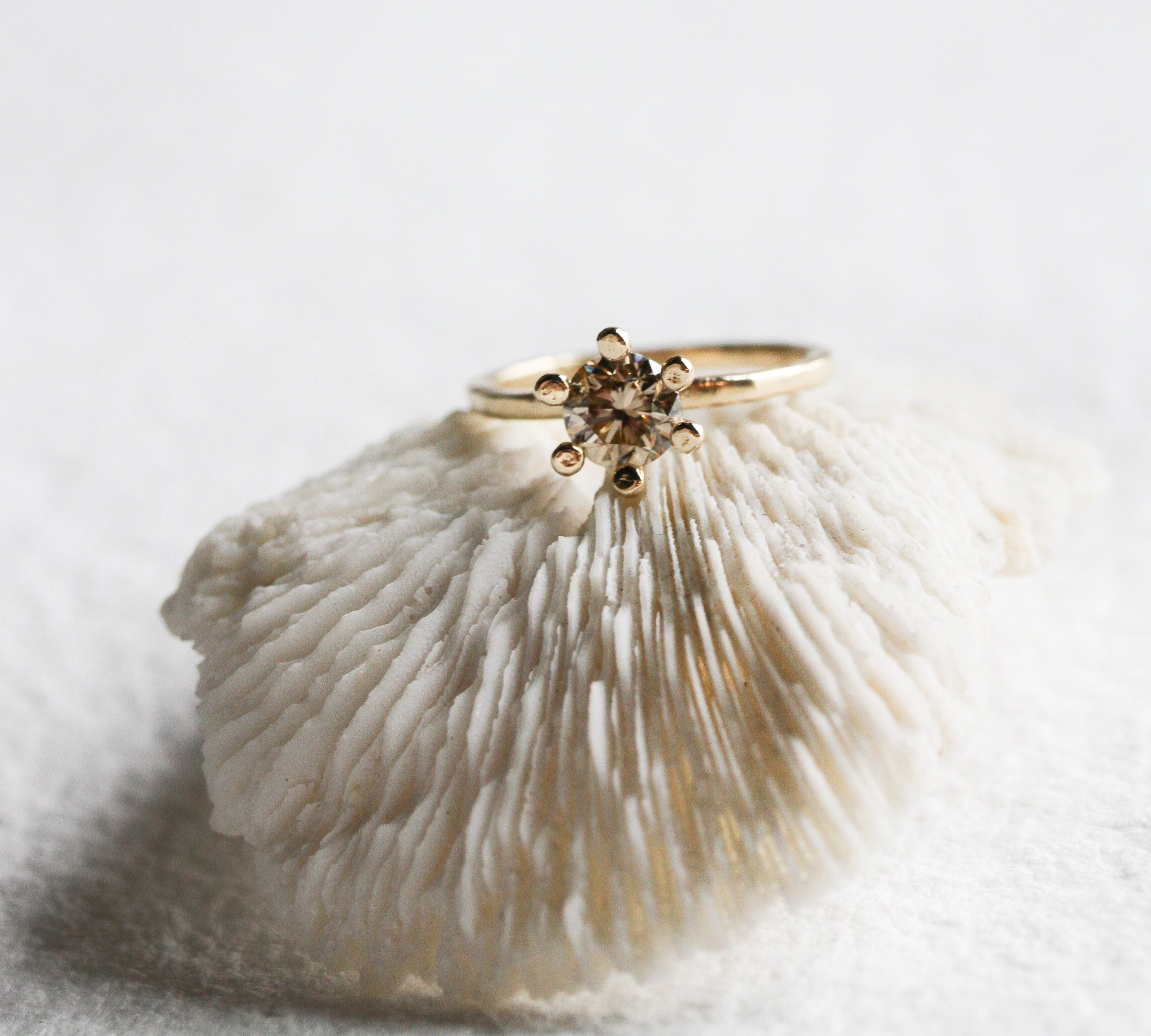 A champagne diamond solitaire from Jane Pope Jewelry — a clear example of how the color reads against yellow gold