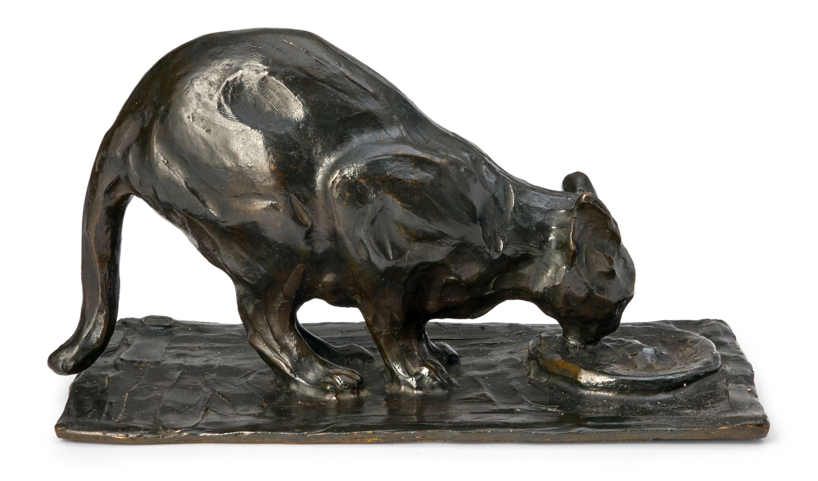Rembrandt Bugatti’s 1906 patinated bronze Petit Chat à L’Écuelle, a small cat crouched at its bowl — the $80,000 to $120,000 top lot of the Bonhams cat sale