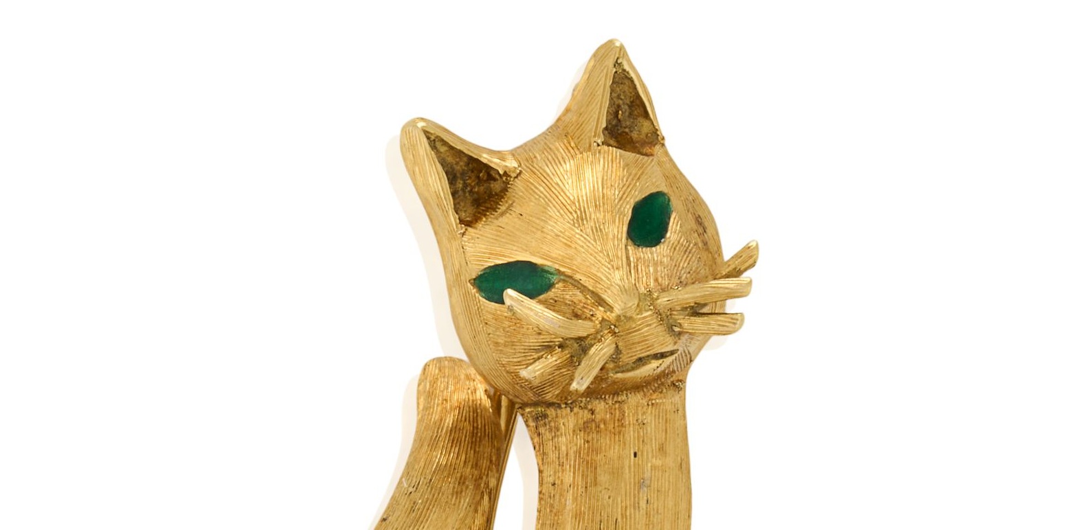 Signed Tiffany & Co. 18K gold cat brooch with green enamel eyes, lot 60 of the Sandy Lerner cat collection at Bonhams