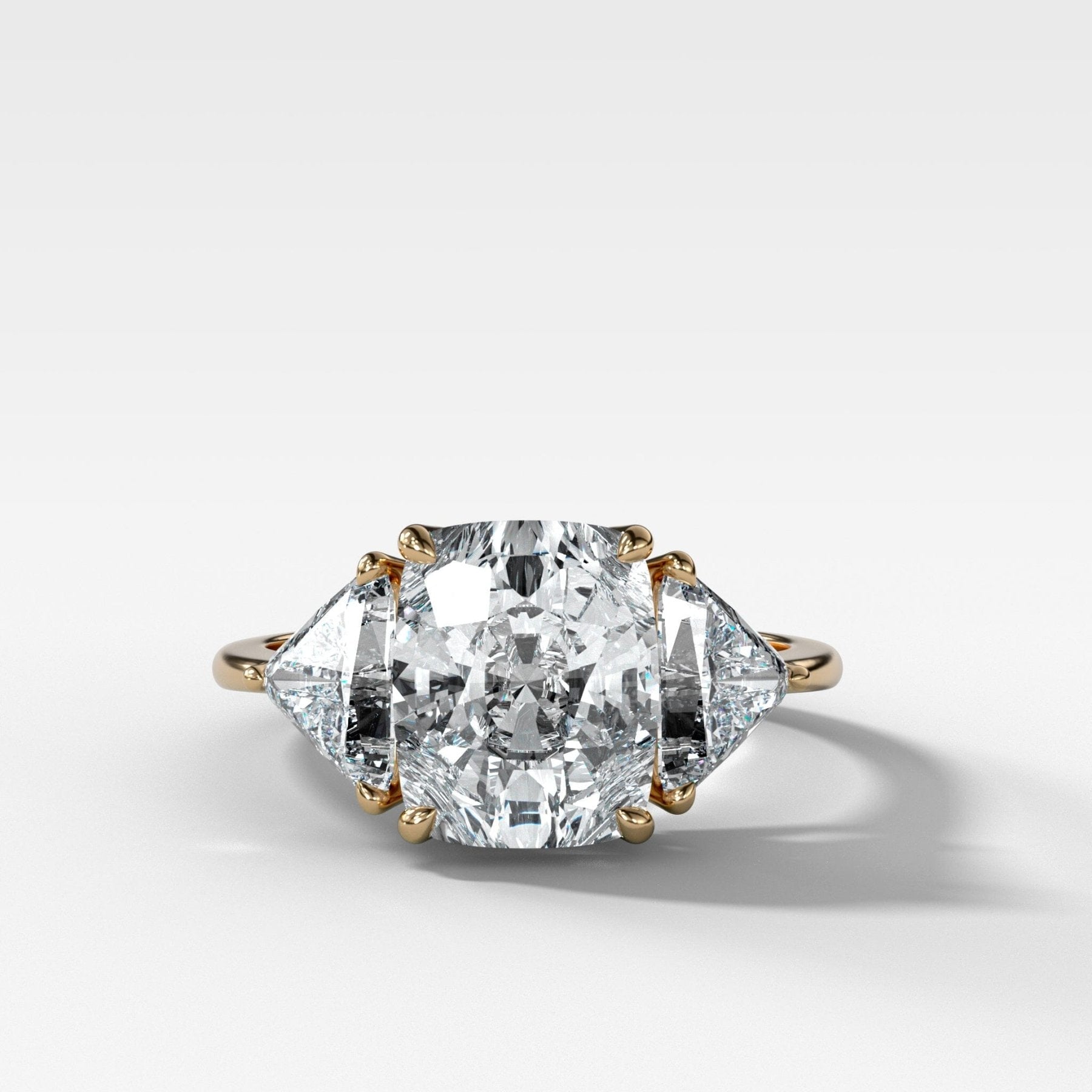 Three-stone elongated cushion engagement ring with shield side stones by GOODSTONE