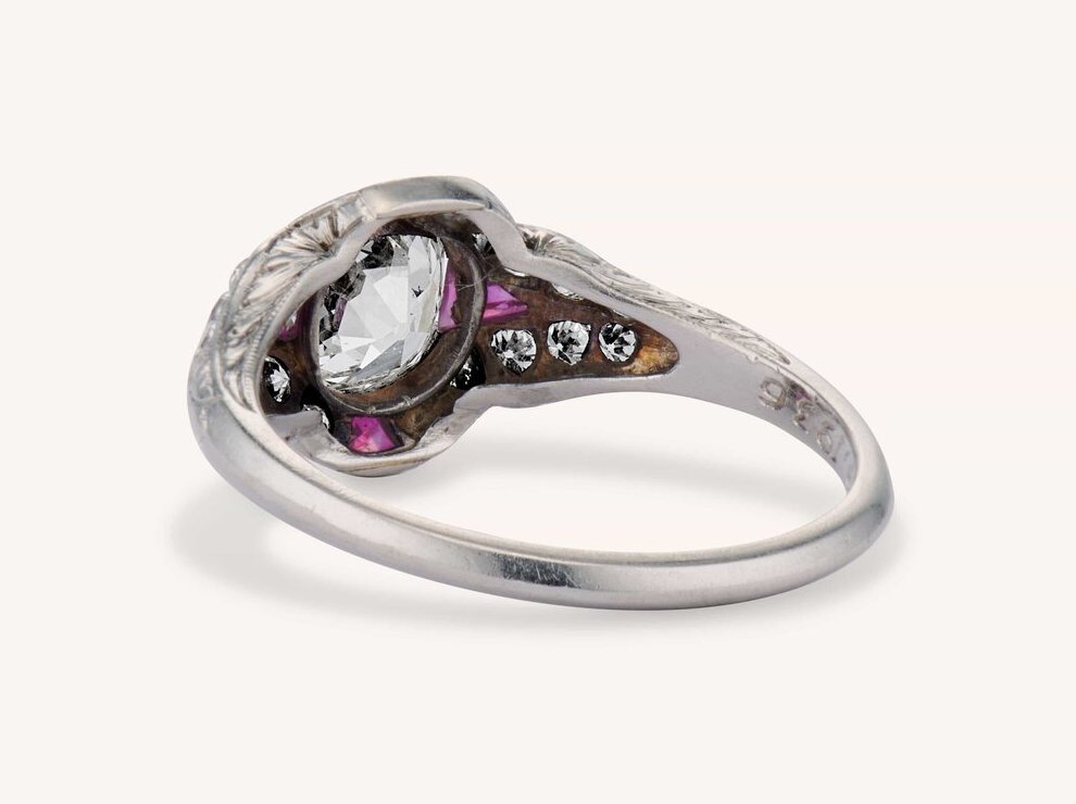 The underside of an Art Deco ring, showing the hand-pierced open gallery, milgrained settings, and engraved shoulders that mark handwork you can see when you flip a piece over, courtesy of Erstwhile Jewelry