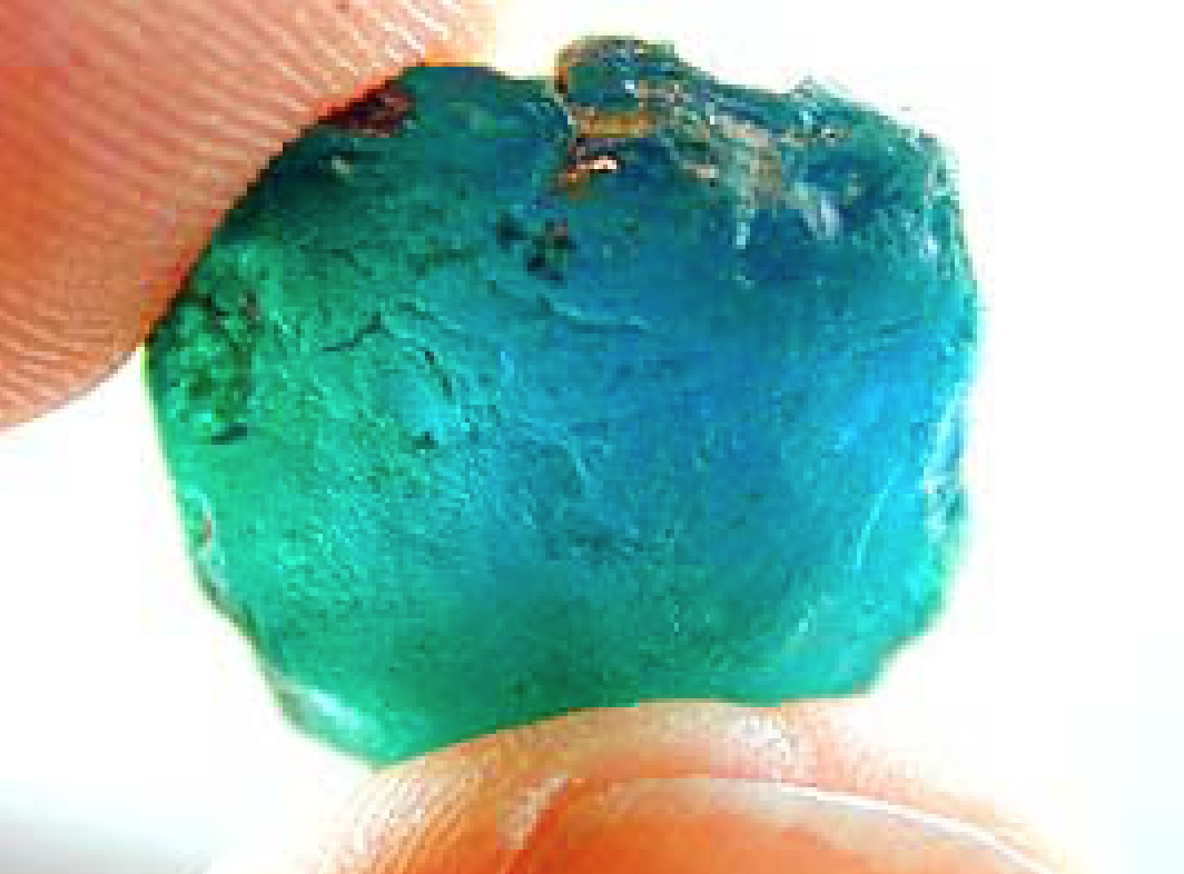 A rough Paraíba tourmaline crystal from Nigeria, one of the three deposits that produce the copper-bearing neon color.