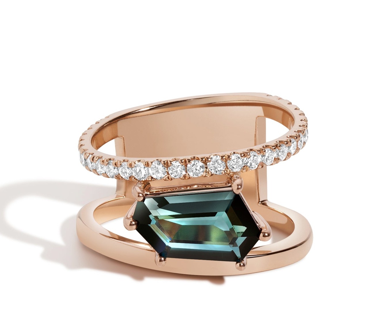 Selin Kent Petra ring, an elongated hexagonal teal tourmaline set sideways beneath a floating pavé bar in rose gold: the architectural settings and unexpected stone placements the brand is known for