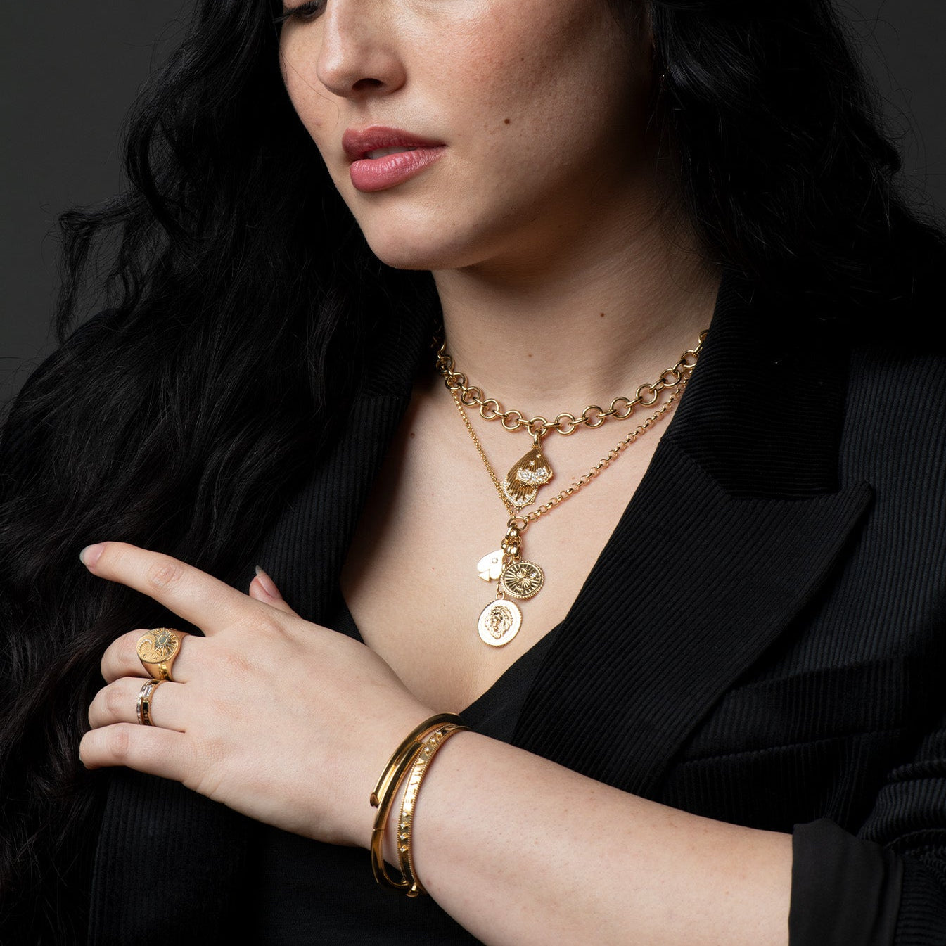 Foundrae layered gold medallion pendants styled over black