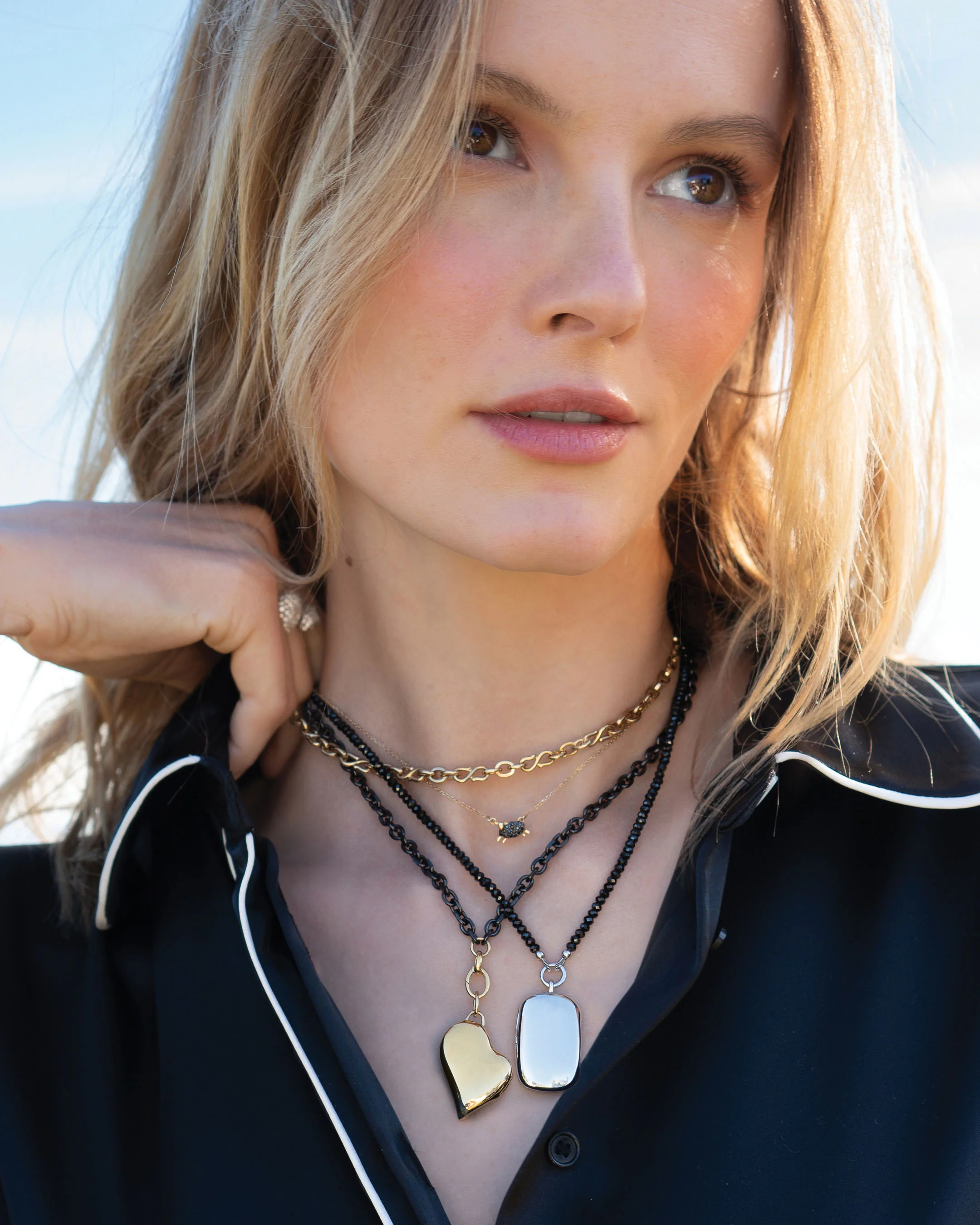 Gold and steel locket pendants on layered black spinel and gold link chains