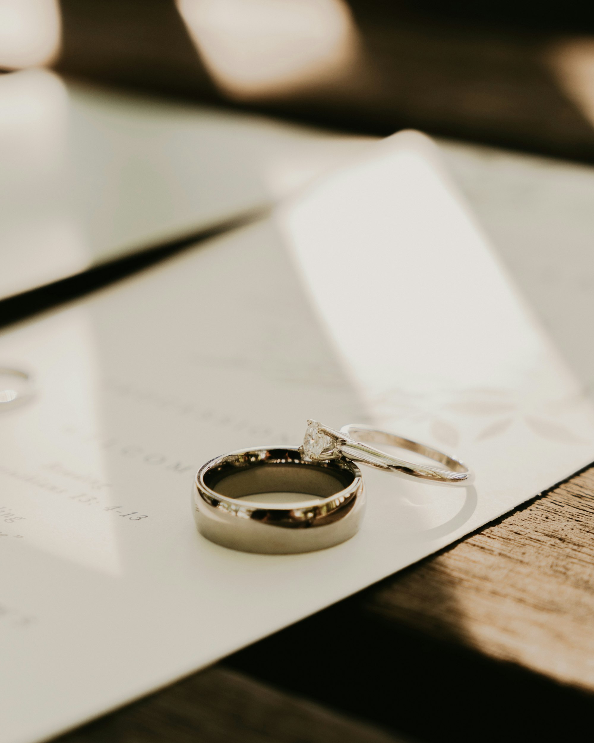Two rings resting on a document in warm light